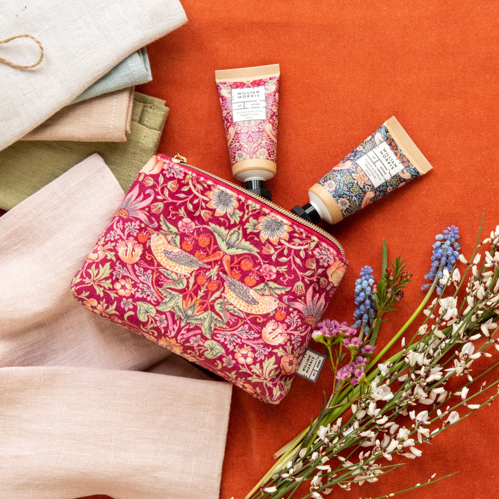 raspberry velvet Strawberry Thief cosmetic bag filled with hand care makes a perfect gift. Tucked inside are two enticingly scented pocket hand creams- from Noble House Gifts and Hampers