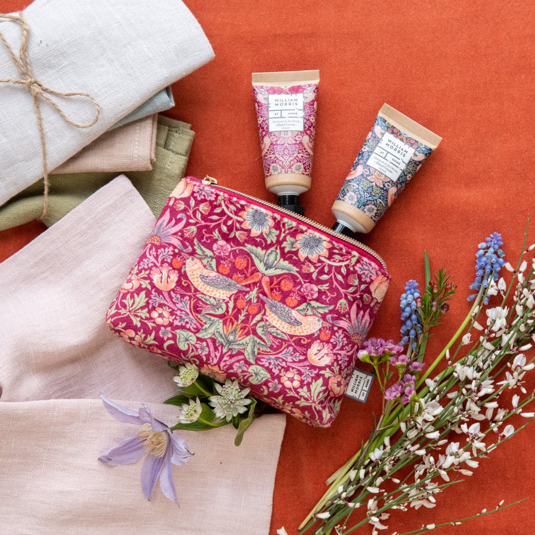 raspberry velvet Strawberry Thief cosmetic bag filled with hand care makes a perfect gift. Tucked inside are two enticingly scented pocket hand creams- from Noble House Gifts and Hampers